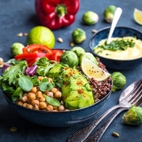 Bowl with healthy salad and dip.