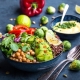 Bowl with healthy salad and dip.