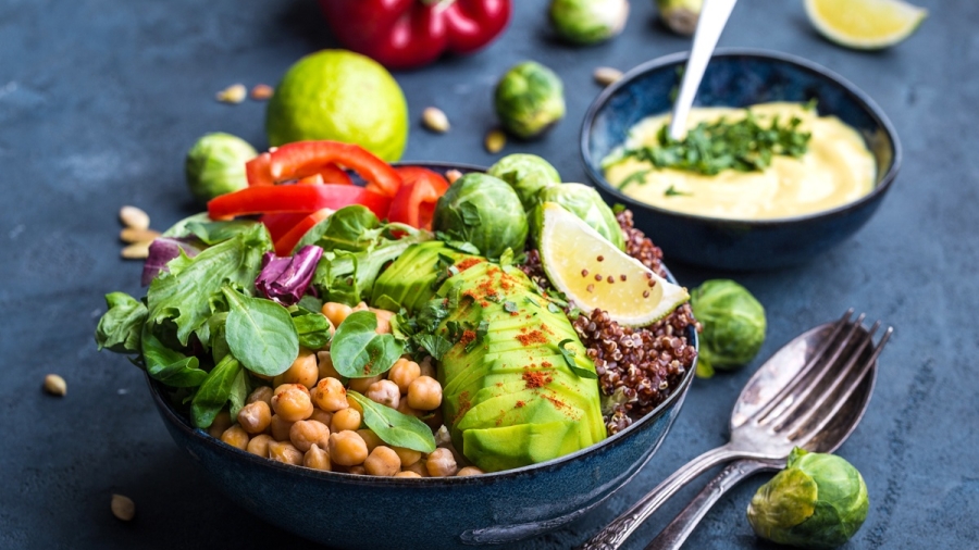 Bowl with healthy salad and dip.