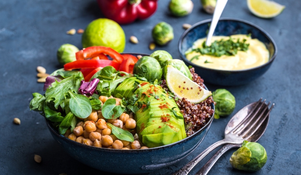 Bowl with healthy salad and dip.